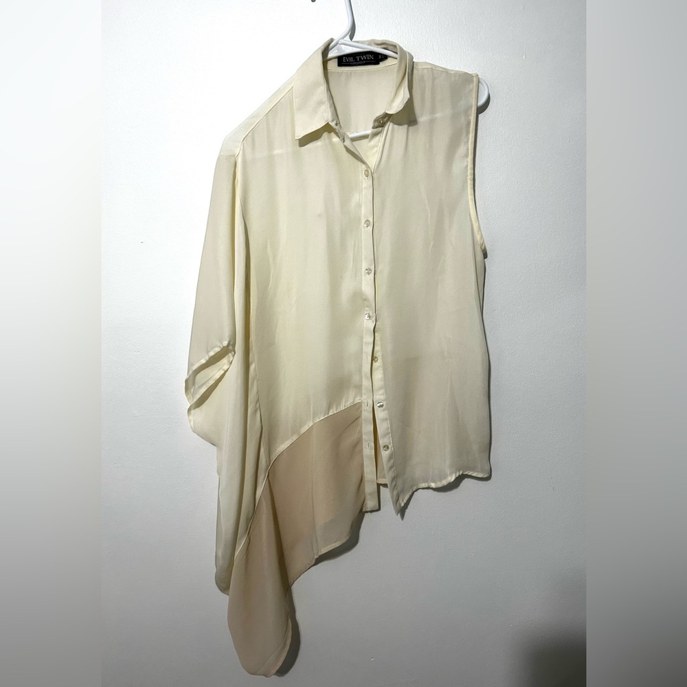 a one sleeved cream/yellow blouse